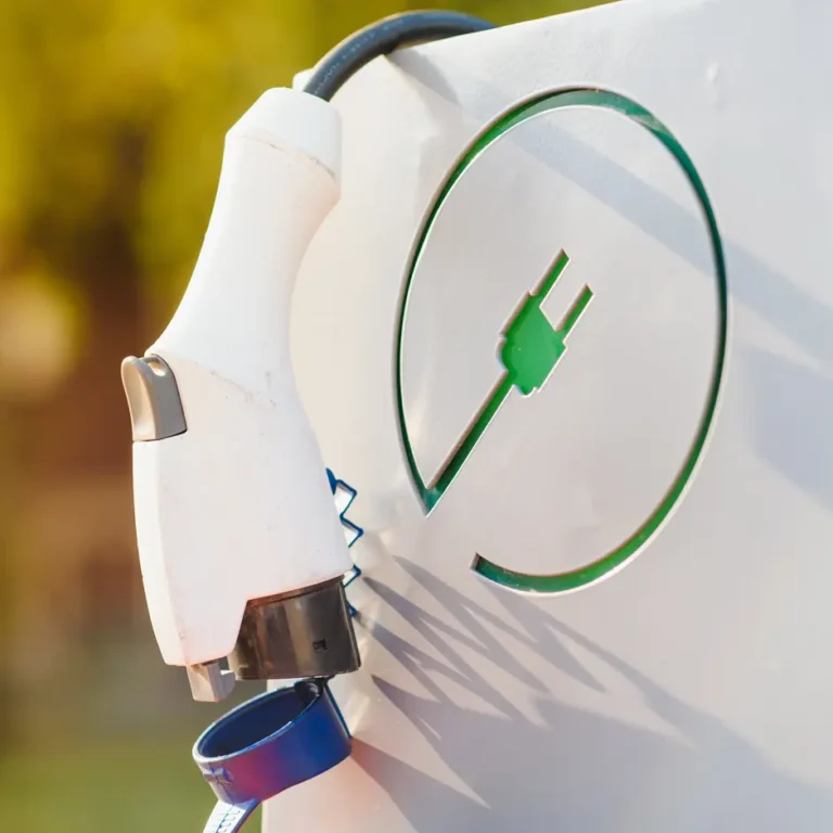 Close-up of an electric vehicle (EV) charging plug connected to a charging station which represents initiatives supported by Suffolk Community Energy Network